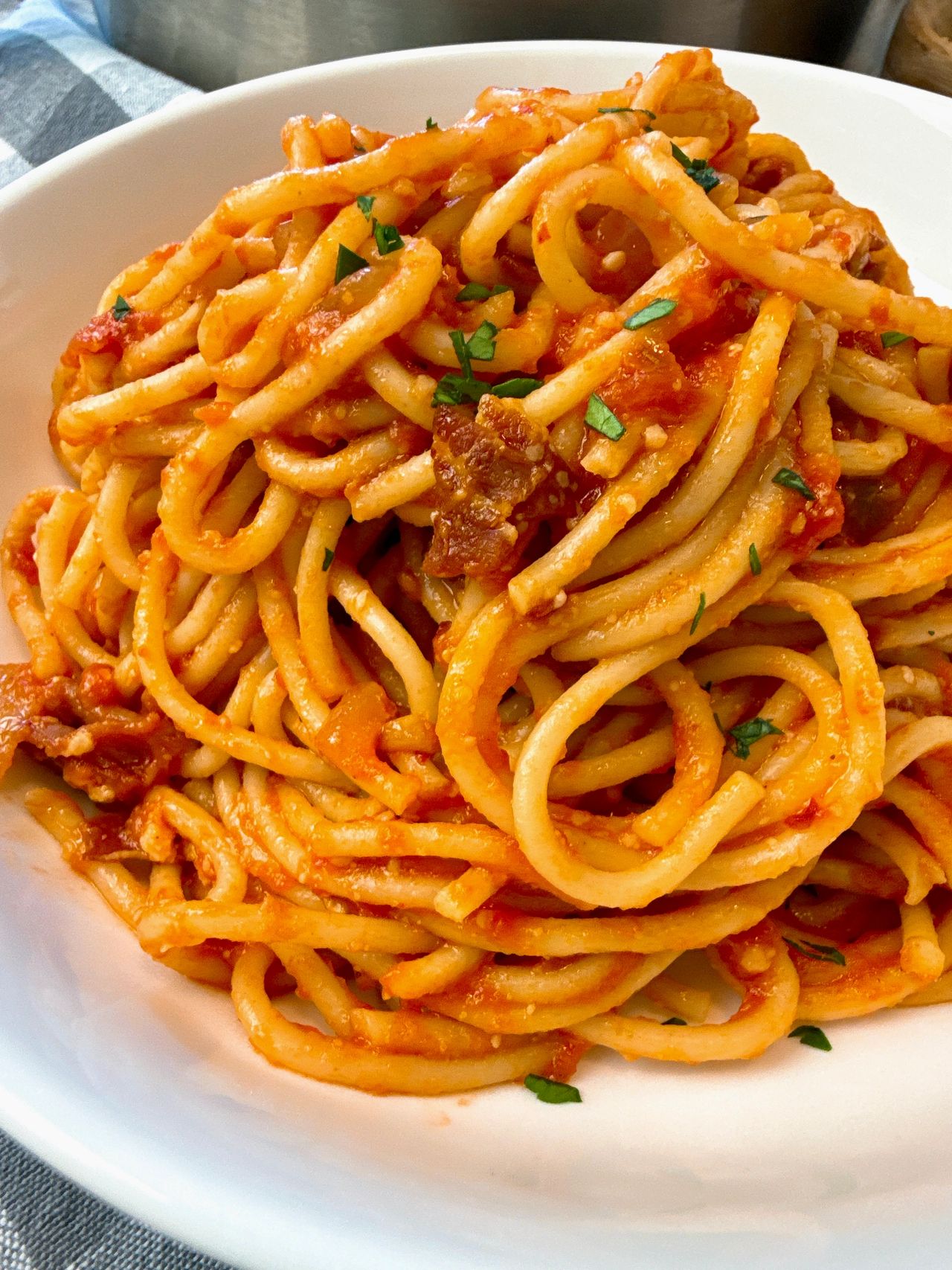 pasta amatriciana in a white bowl