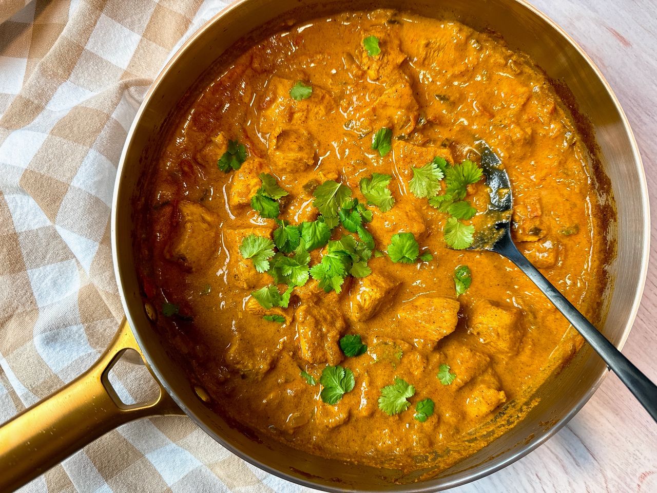 Chicken Curry chicken curry topped with cilantro in a silver pan