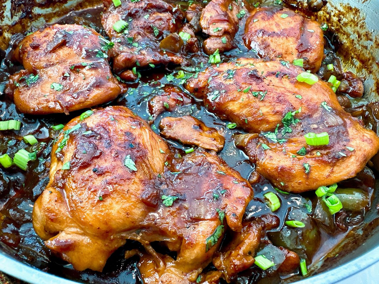 chicken thighs in a skillet with Asian glaze
