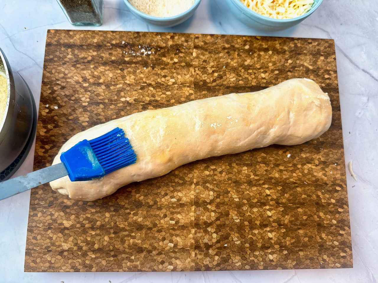 brushing pepperoni bread with butter