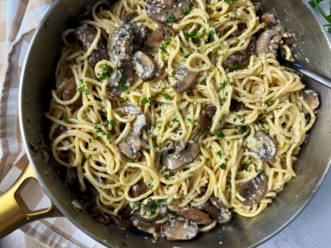 Pasta with Mushrooms in a skillet with a black fork
