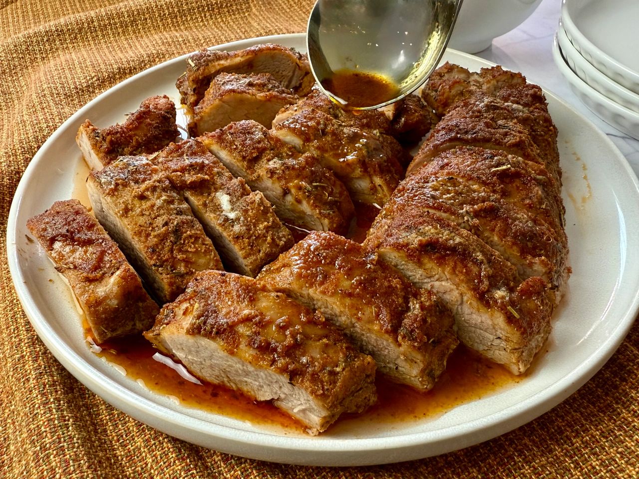 sliced pork tenderloin on a white plate