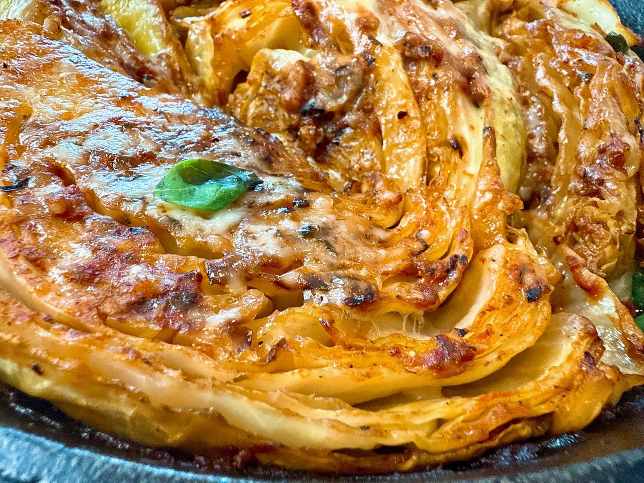 cabbage and marinara sauce in a cast iron skillet