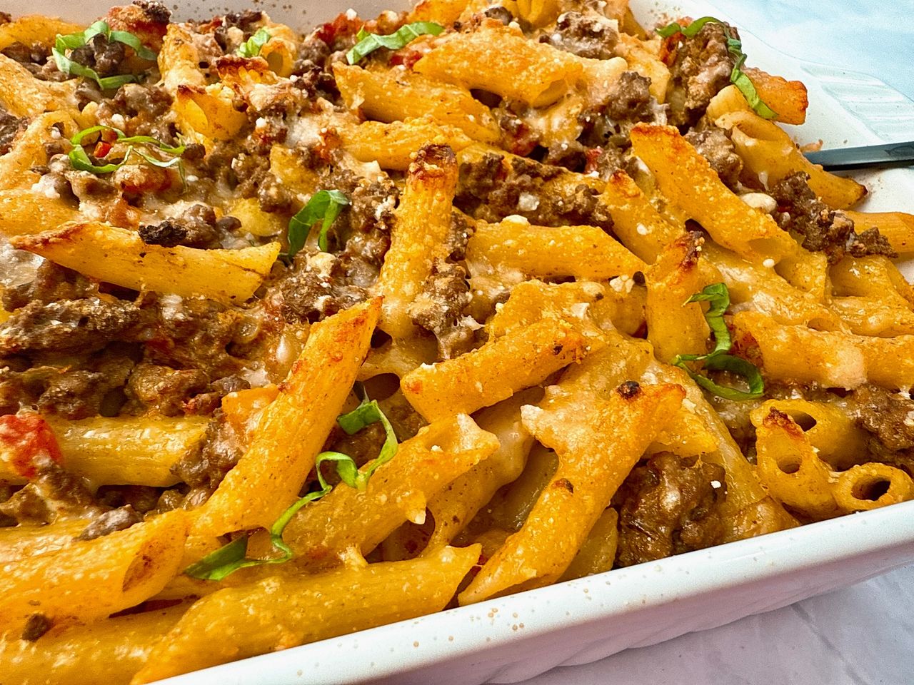 pasta and beef in a white baking dish