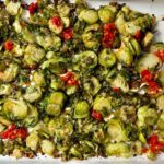 Shaved Brussels Sprouts with Calabrian Peppers on a white baking pan