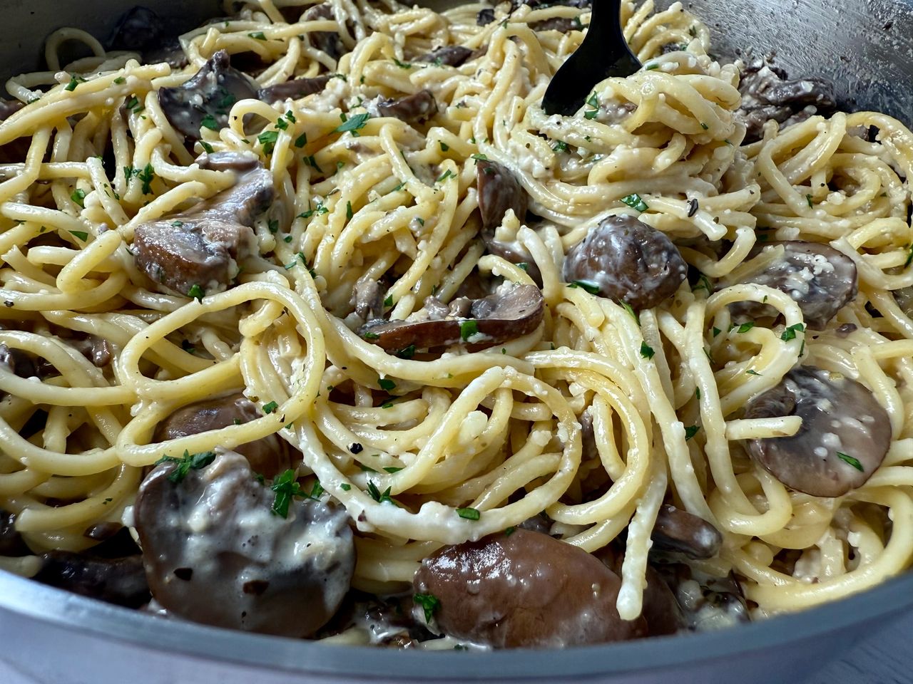 Pasta with Mushrooms in a skillet with a black fork
