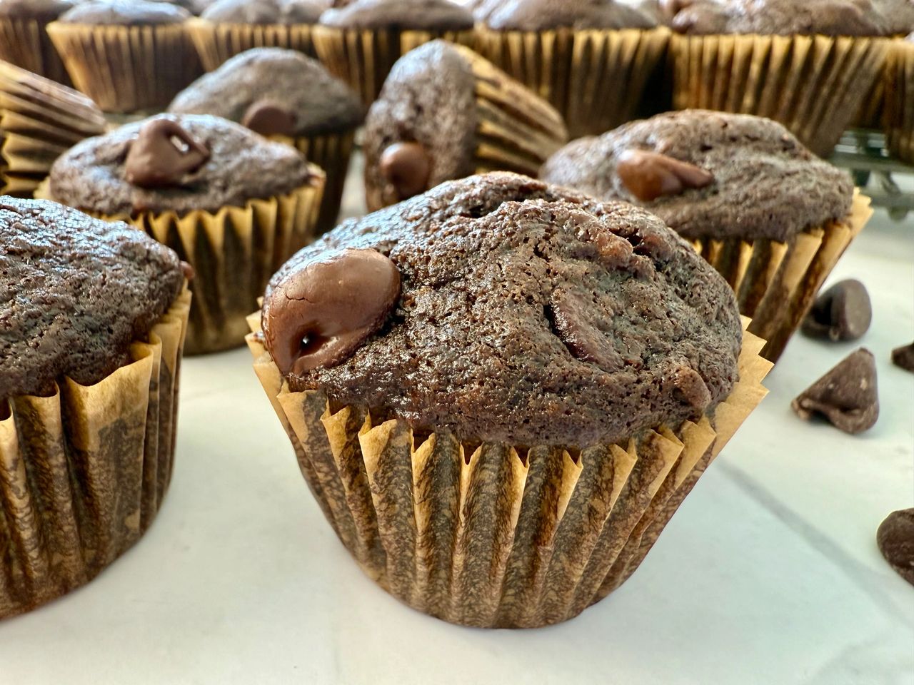 mini chocolate banana muffins on a white surface