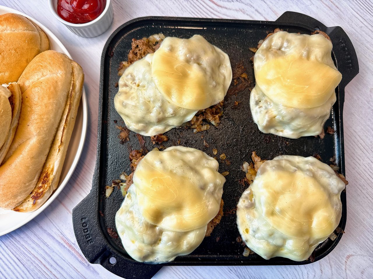philly cheesesteak filling on a cast iron griddle