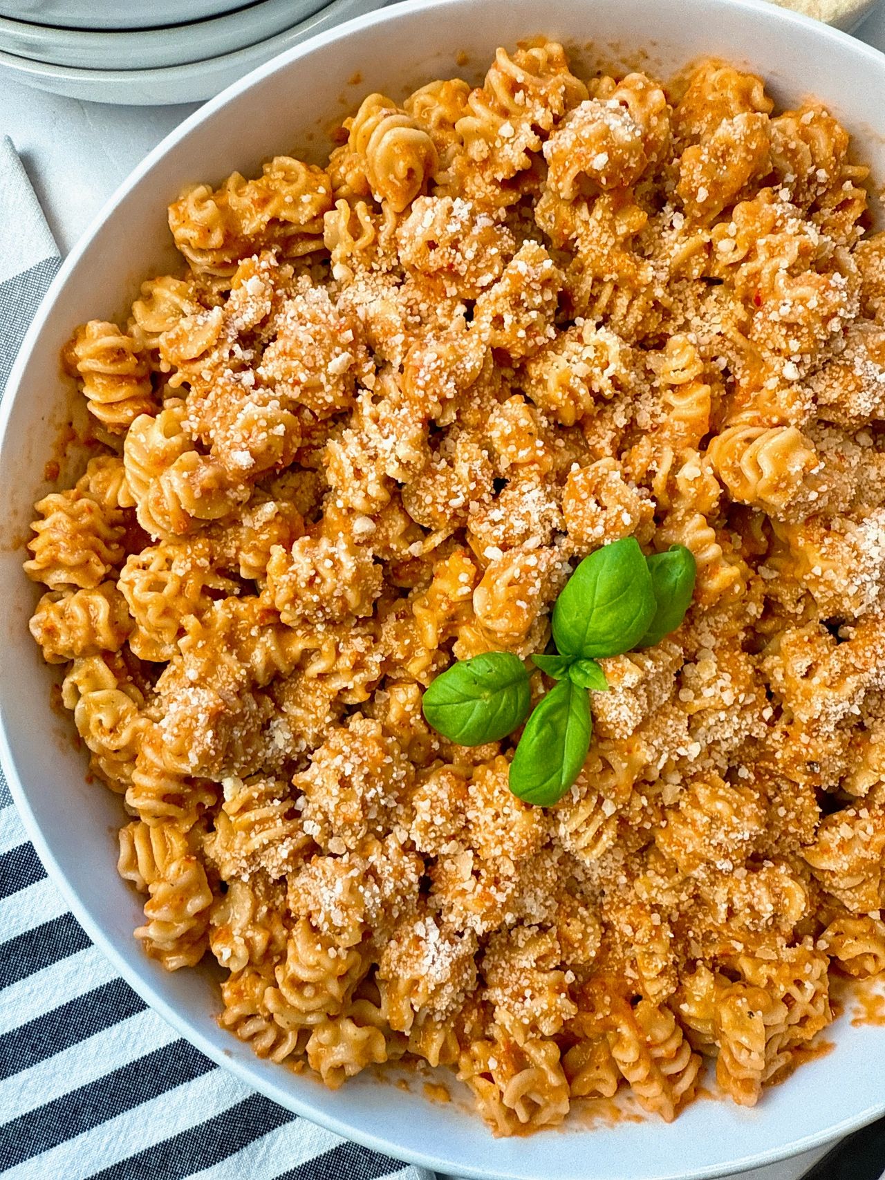 radiatori pasta with roasted red pepper sauce in a white bowl