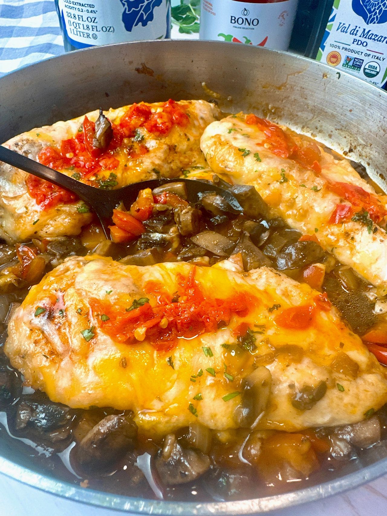 chicken breasts and Italian peppers in a pan