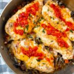 chicken breasts and Italian peppers in a pan