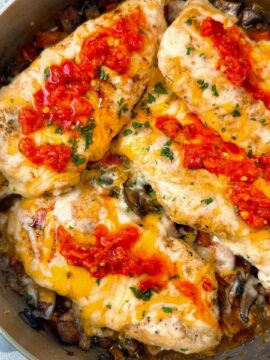 chicken breasts and Italian peppers in a pan