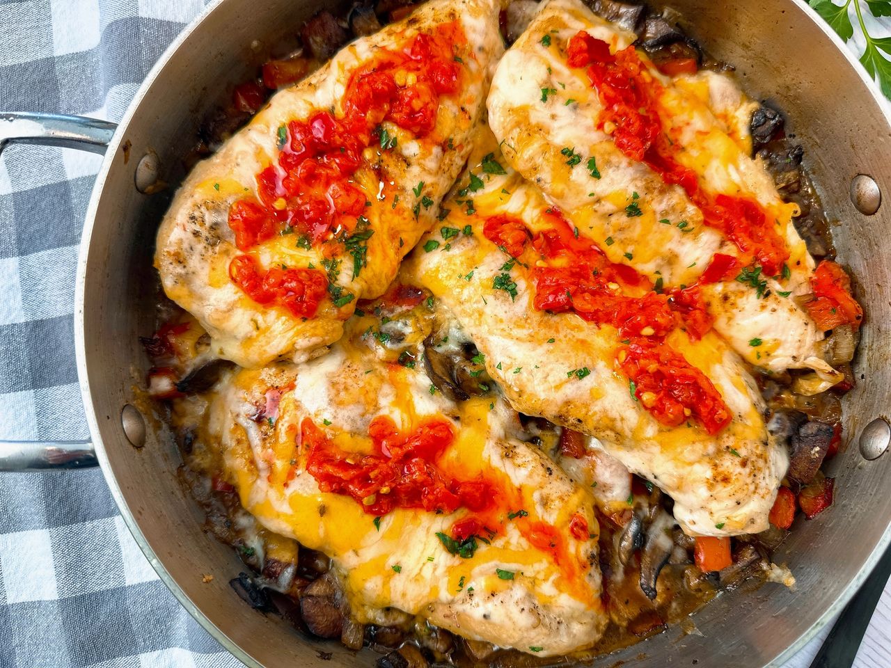 chicken breasts and Italian peppers in a pan