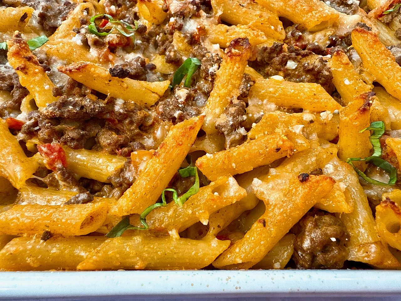 pasta and beef in a white baking dish