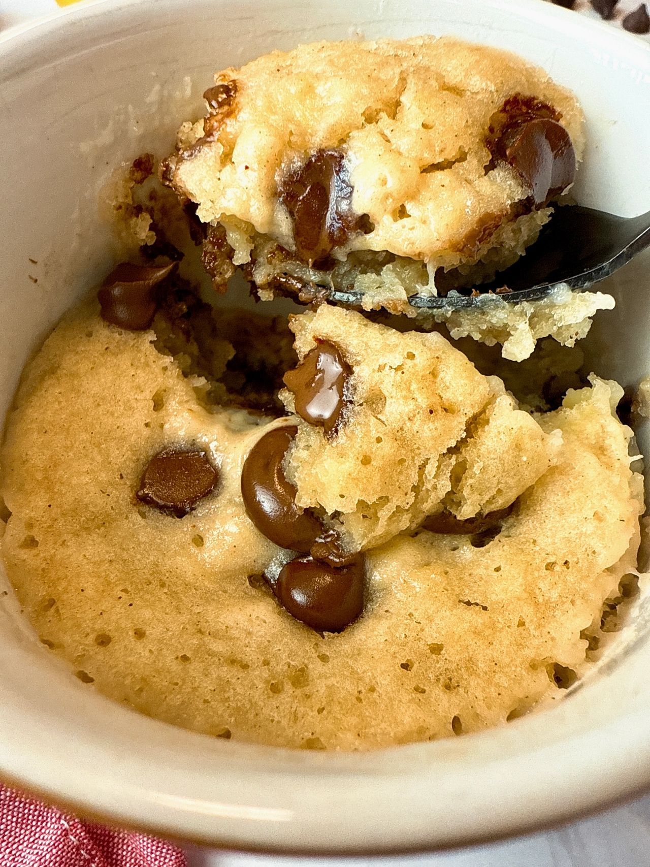 chocolate chip banana bread mug cake with a spoon