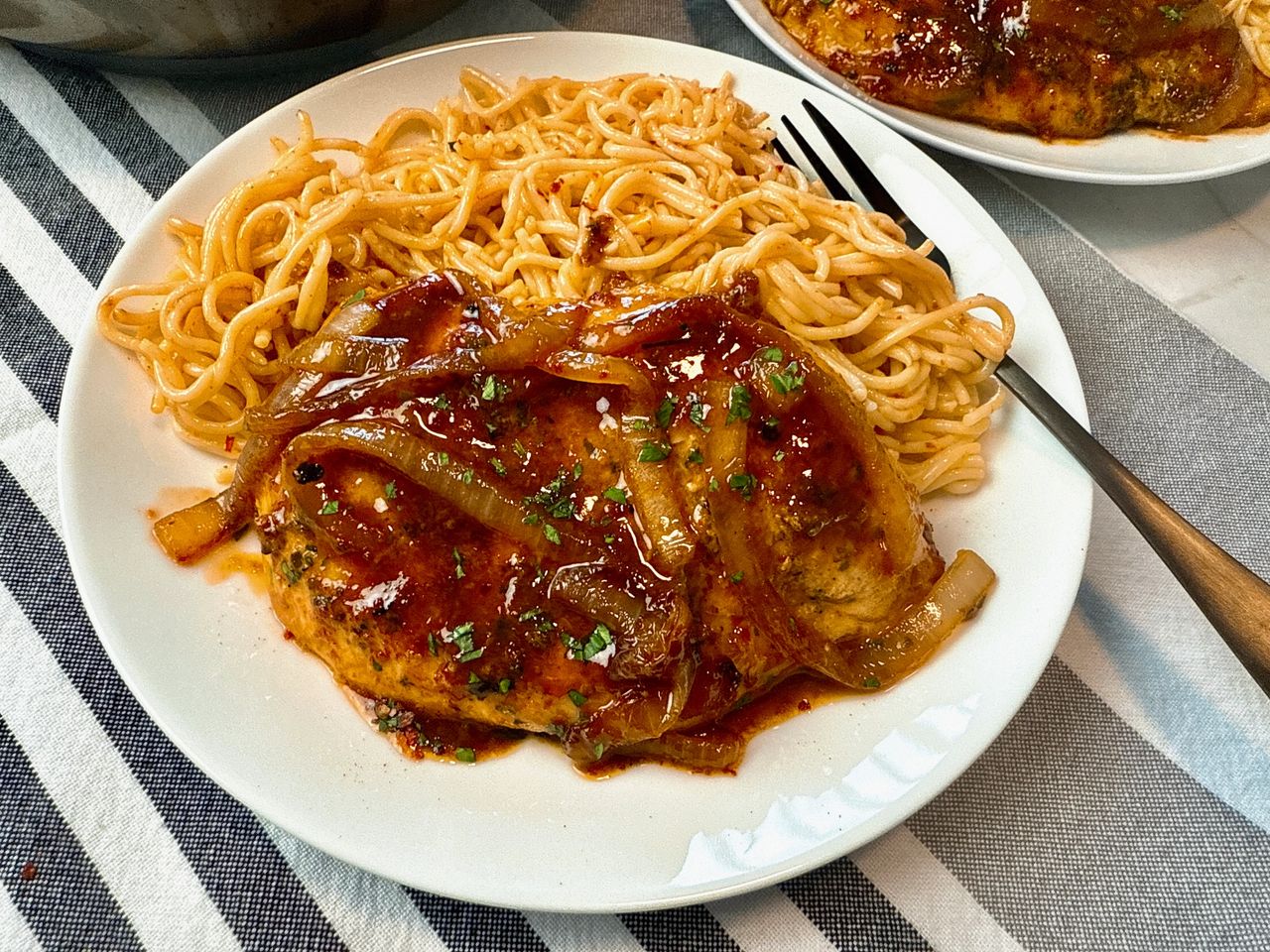 spicy hoisin chicken and noodles on a white plate