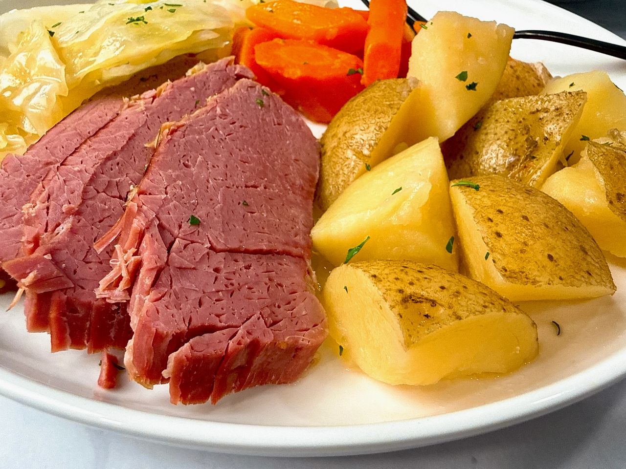 Corned Beef and Cabbage on a white serving plate