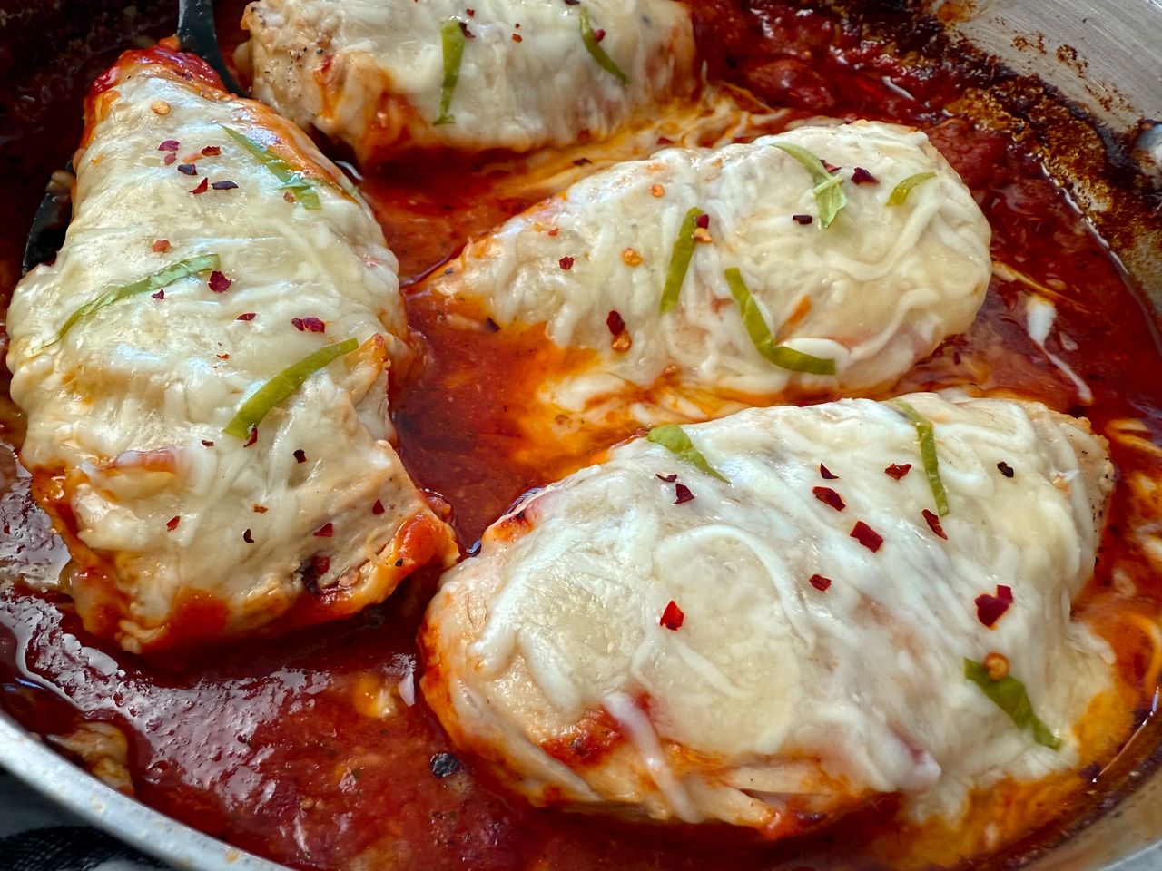 chicken with marinara sauce and cheese in a deep skillet