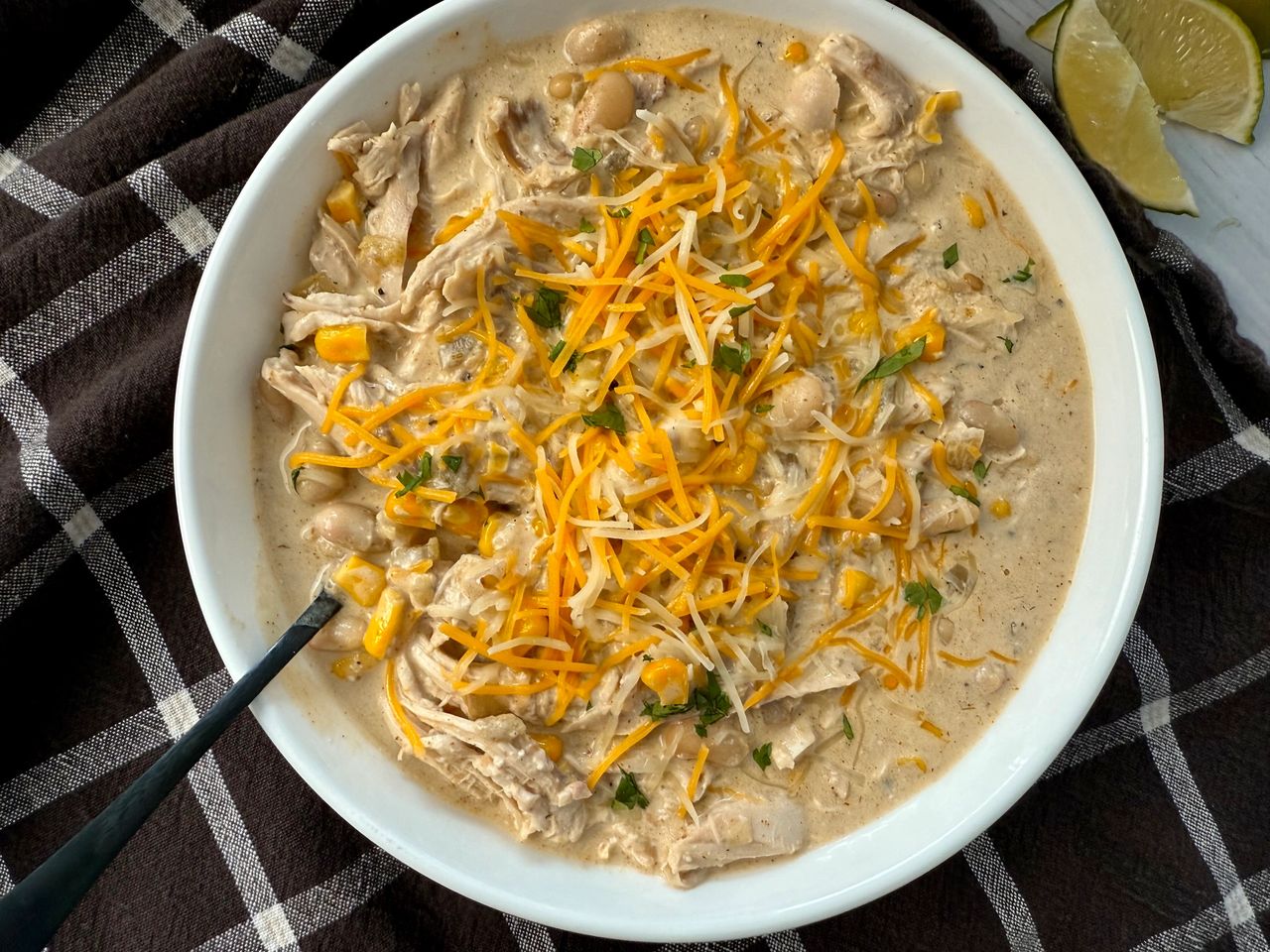 White Chicken Chili white chicken chili in a white bowl on a brown kitchen towel