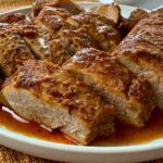 sliced pork tenderloin on a white plate