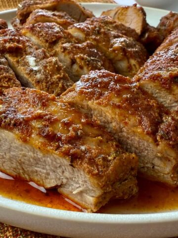 sliced pork tenderloin on a white plate
