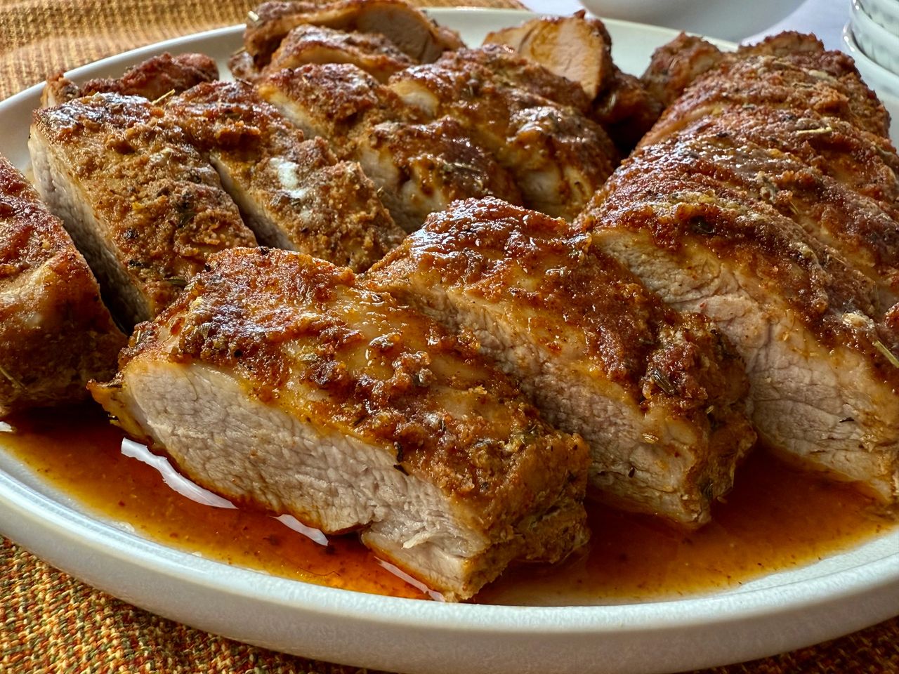 sliced pork tenderloin on a white plate