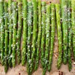 roasted asparagus on a sheet pan lined with parchment paper