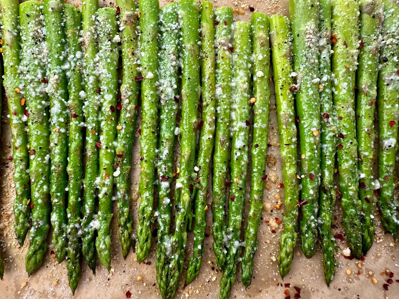 roasted asparagus on a sheet pan lined with parchment paper