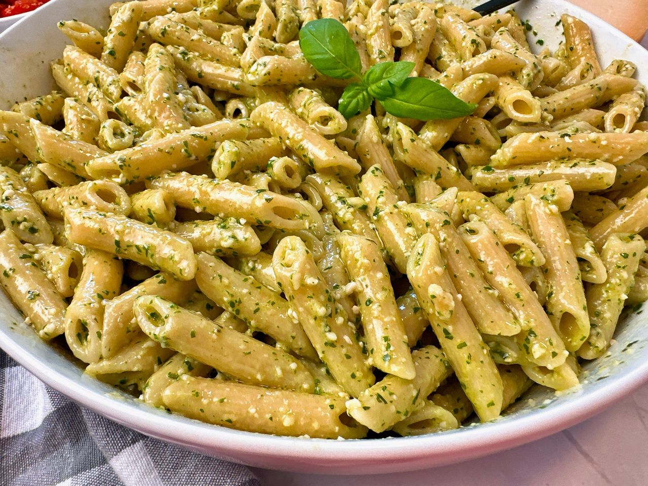 penne pasta with pesto and blistered tomatoes