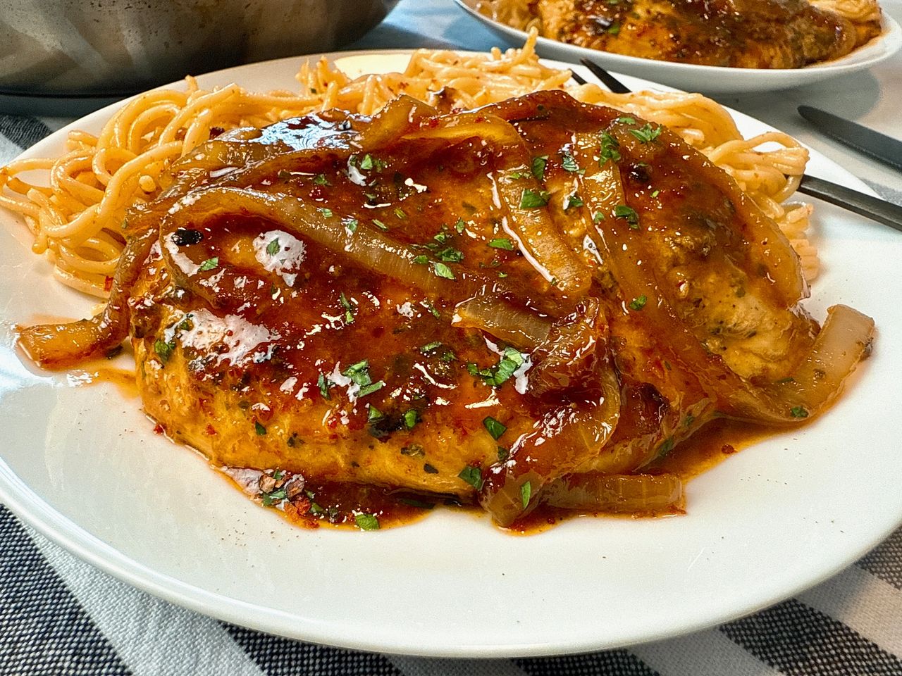 spicy hoisin chicken and noodles on a white plate