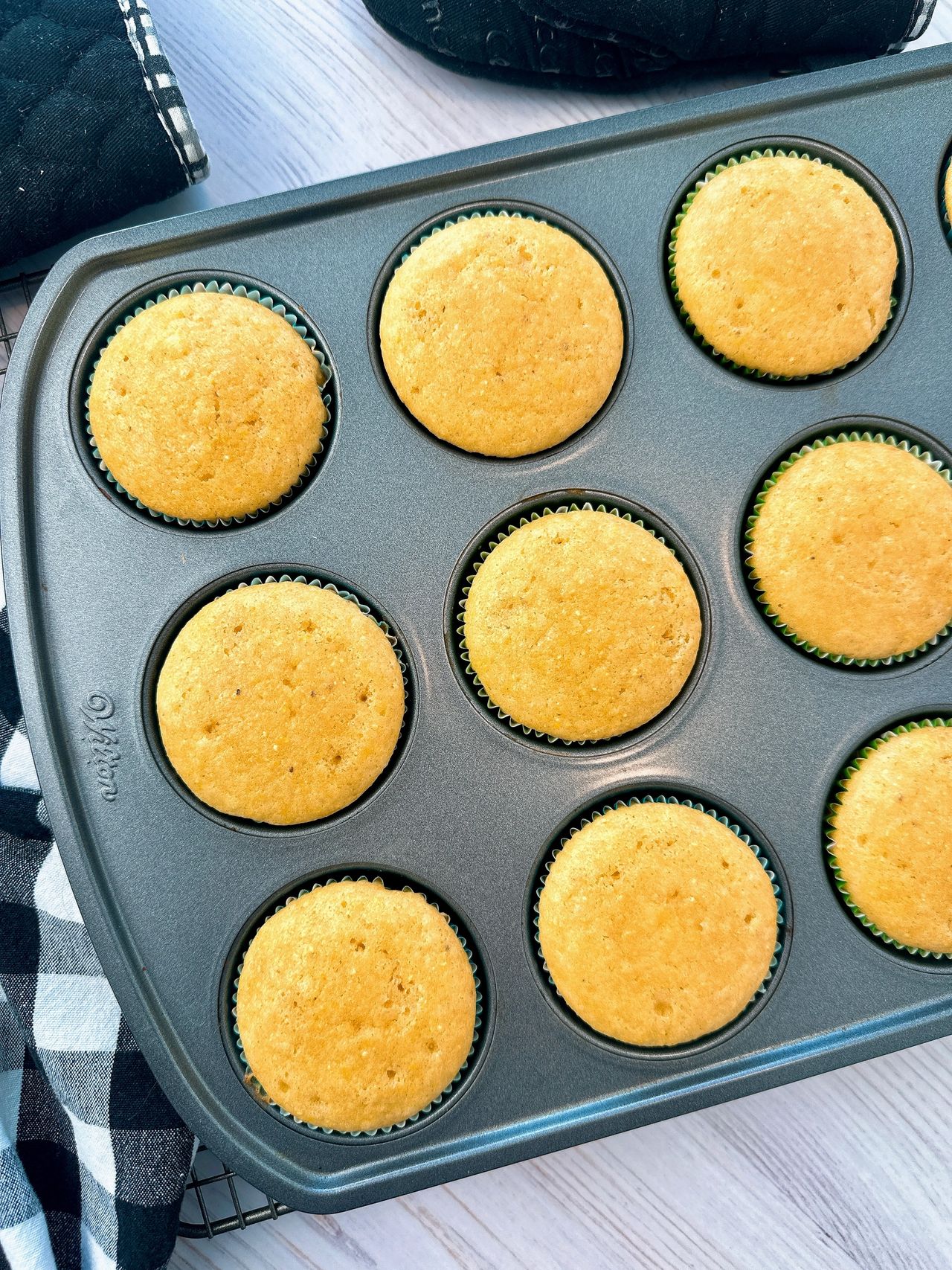 cornbread muffins on a wire rack and white counter