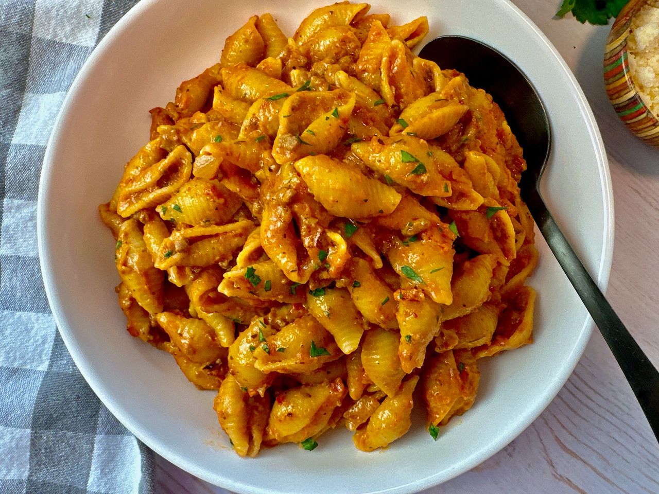 beef and pasta in a white bowl