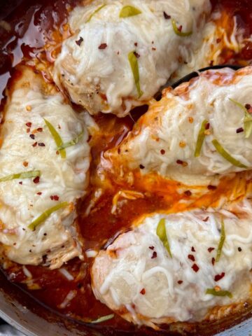 chicken with marinara sauce and cheese in a deep skillet