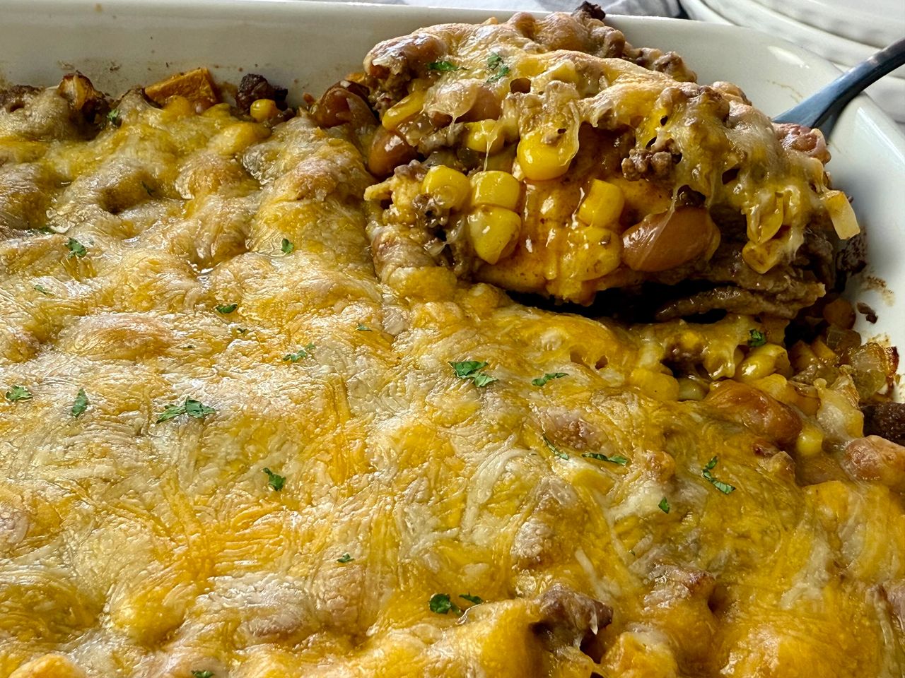 enchilada casserole in a white baking dish