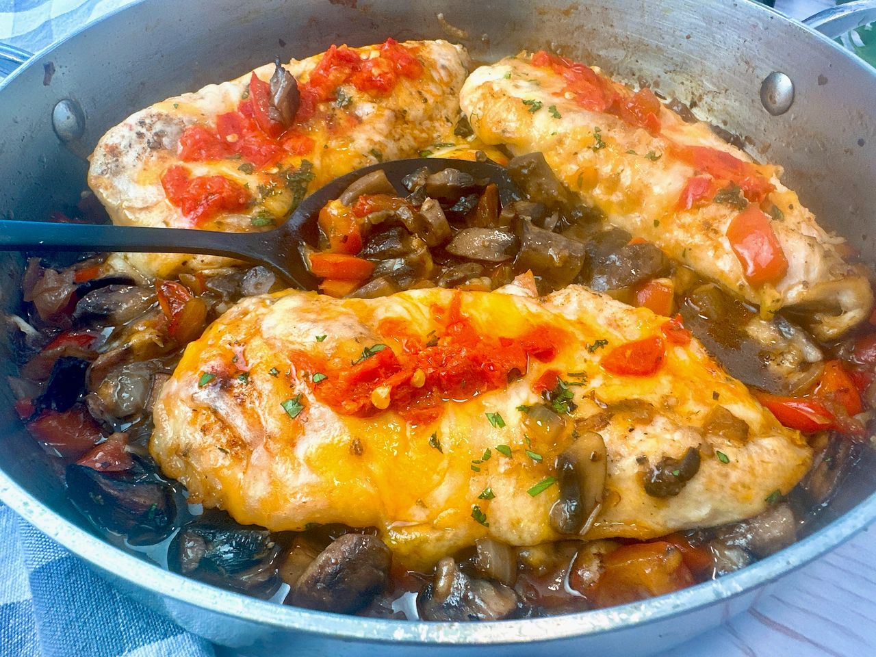 chicken breasts and Italian peppers in a pan