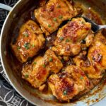 teriyaki chicken in a pan with a serving spoon