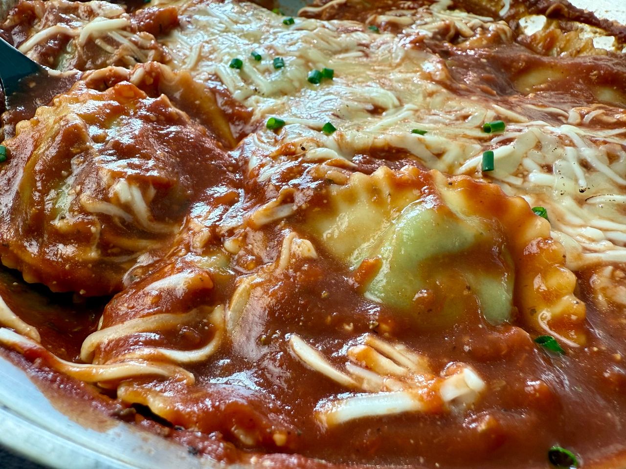 spinach ravioli and marinara sauce with mozzarella cheese