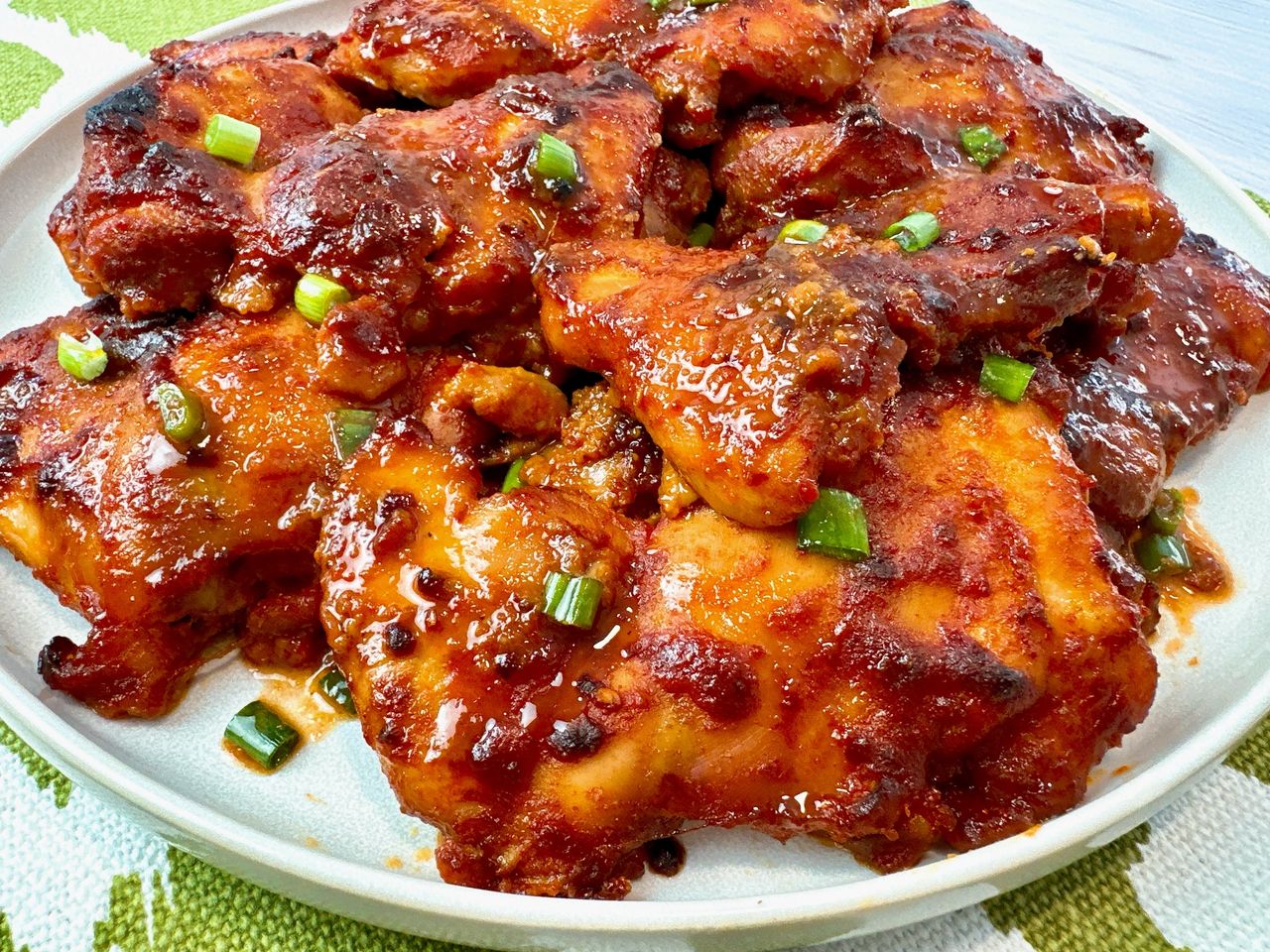 gochujang chicken thighs on a white plate