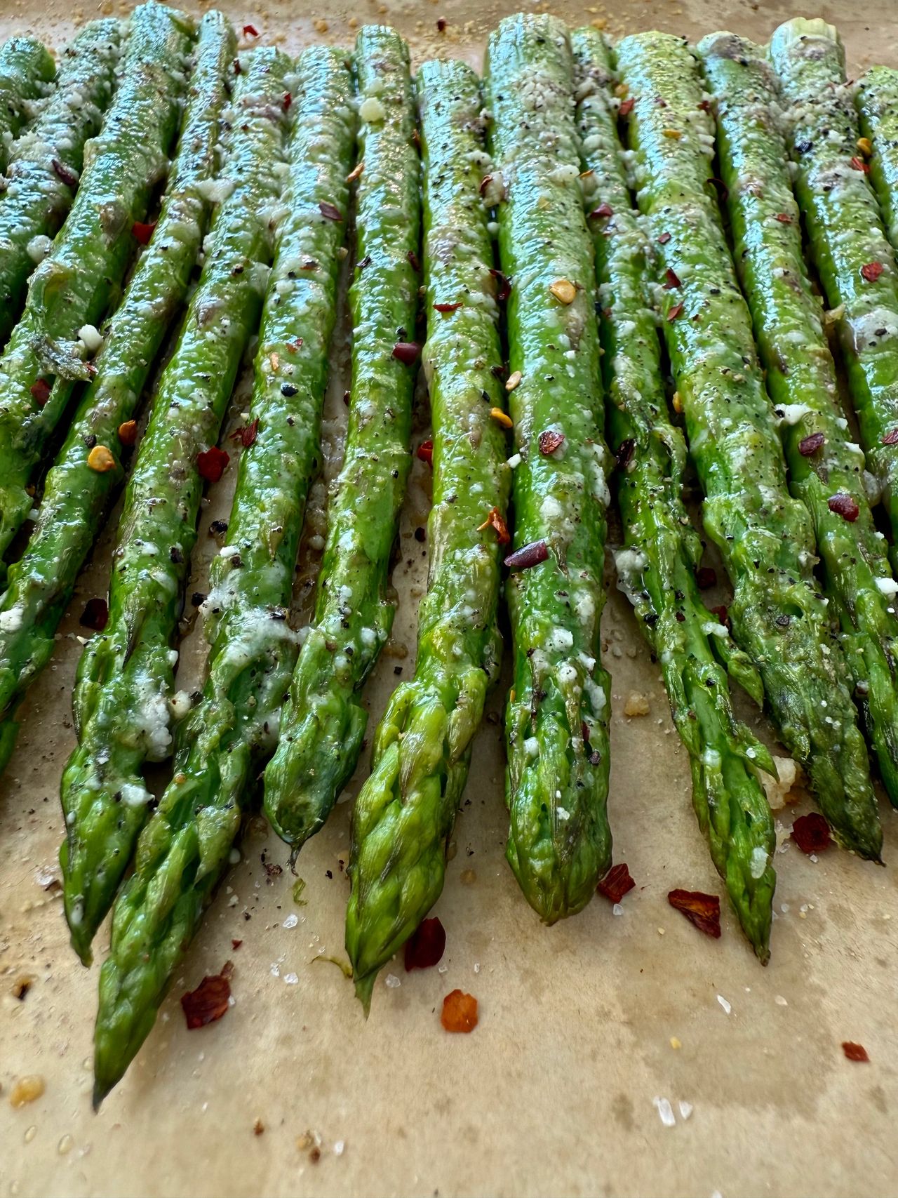 roasted asparagus on a sheet pan lined with parchment paper