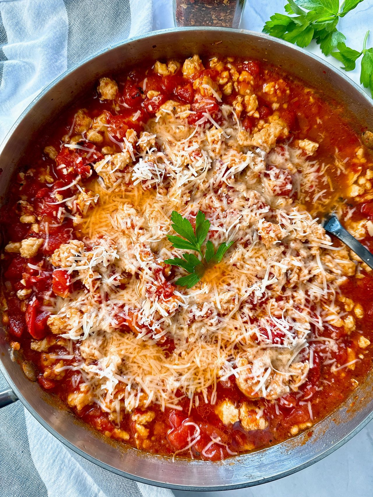 ground chicken arrabbiata with cheese in a silver pan
