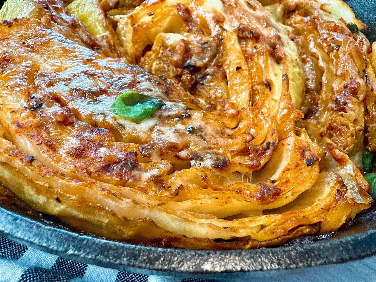 cabbage and marinara sauce in a cast iron skillet