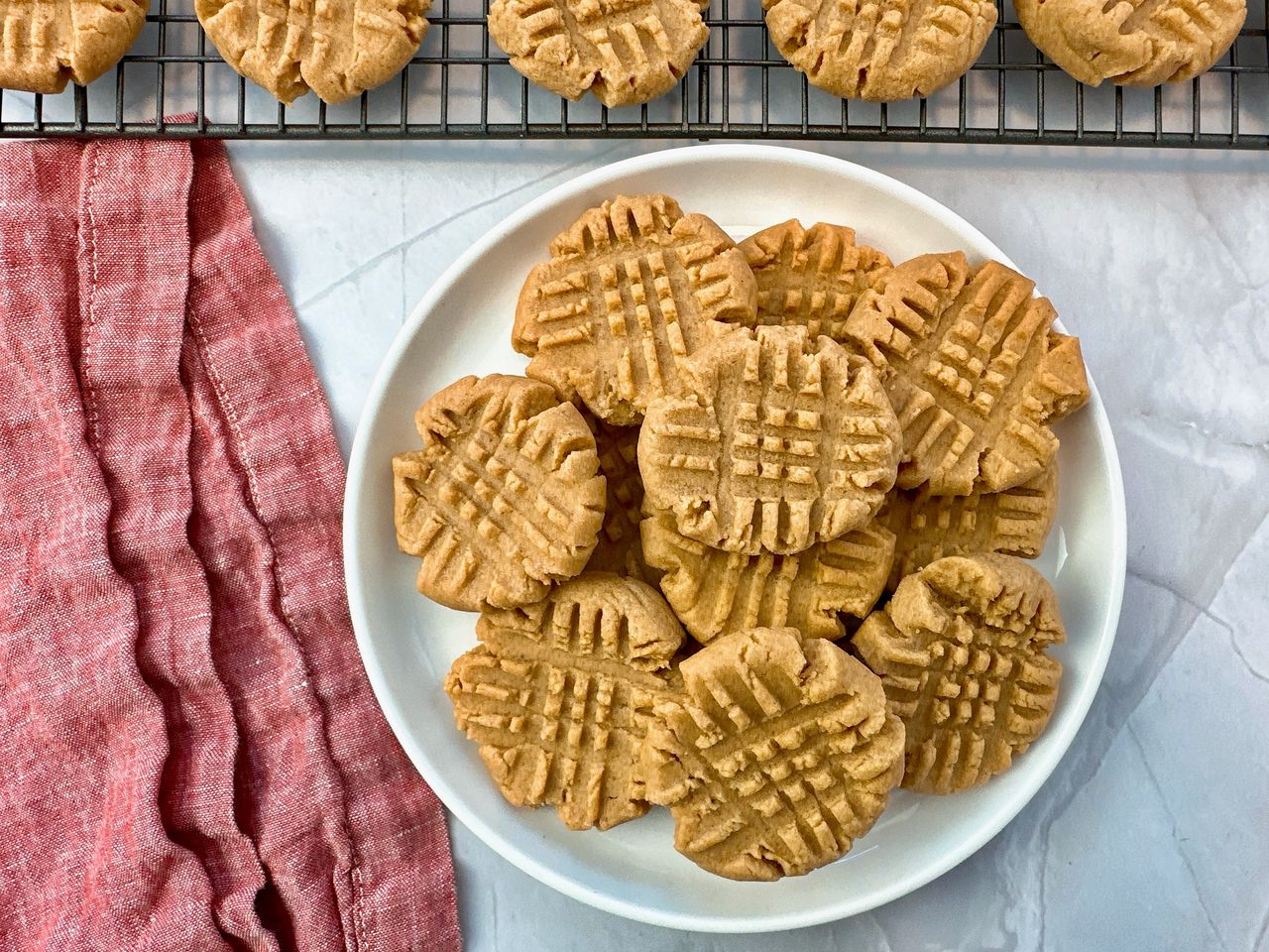 stacked peanut butter cookies on a white background