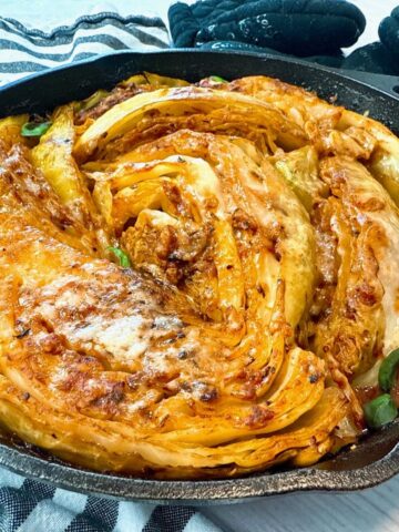 cabbage and marinara sauce in a cast iron skillet