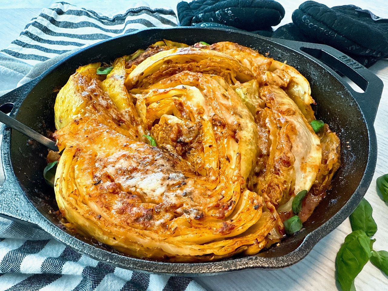 cabbage and marinara sauce in a cast iron skillet