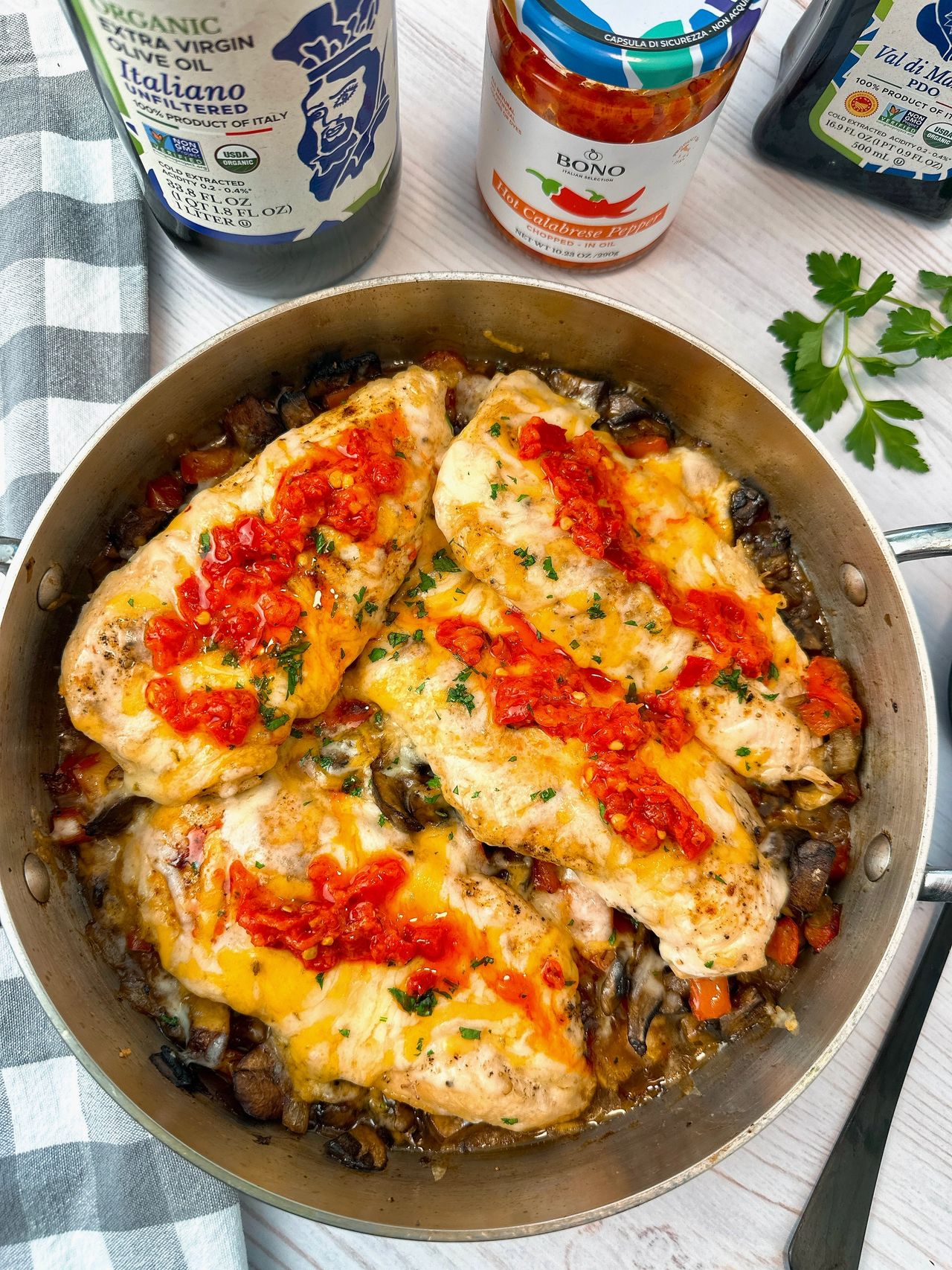 chicken breasts and Italian peppers in a pan