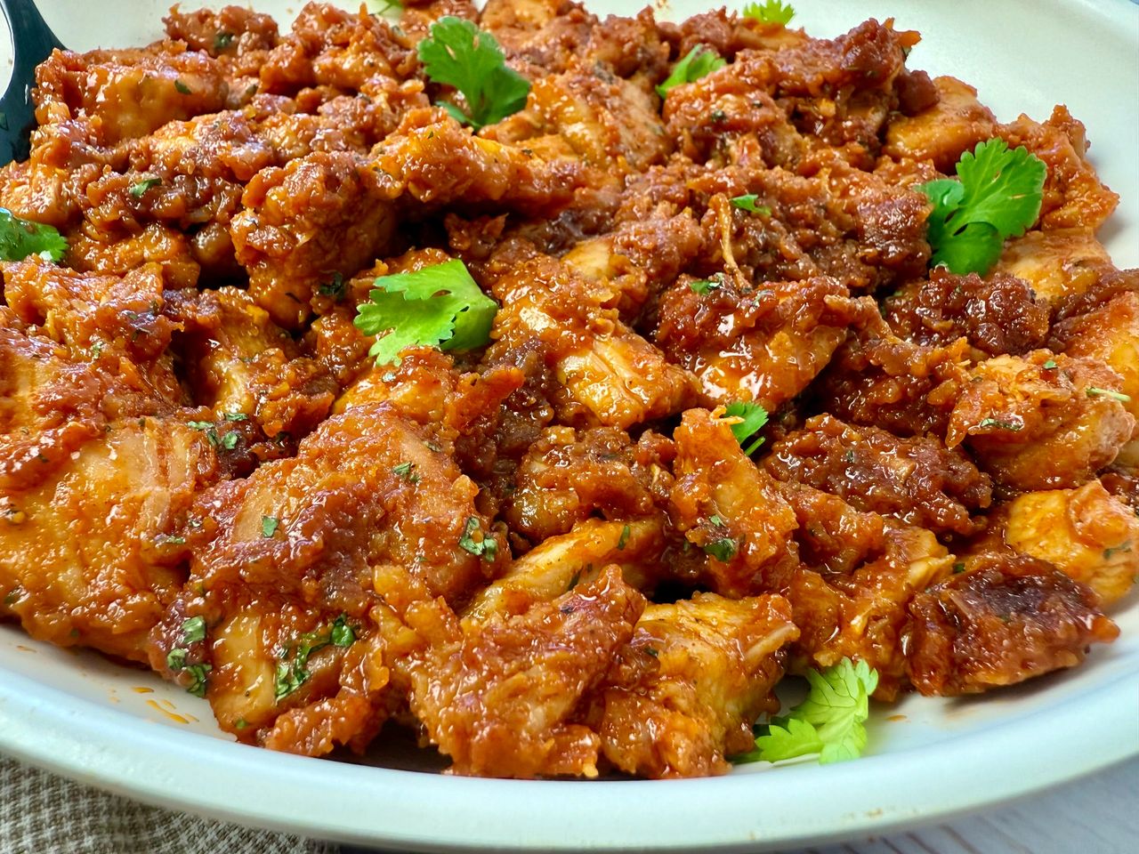 gochujang chicken in a white skillet