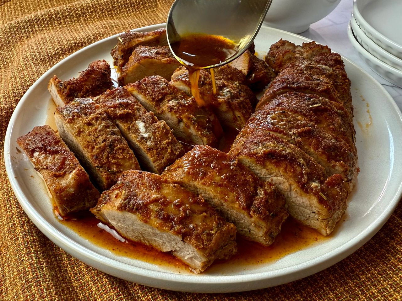 sliced pork tenderloin on a white plate