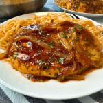 spicy hoisin chicken and noodles on a white plate