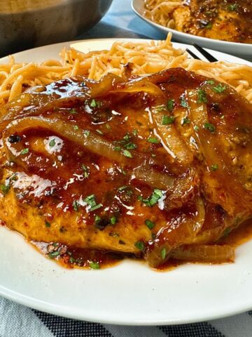 spicy hoisin chicken and noodles on a white plate