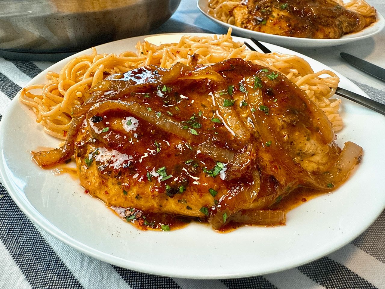 spicy hoisin chicken and noodles on a white plate